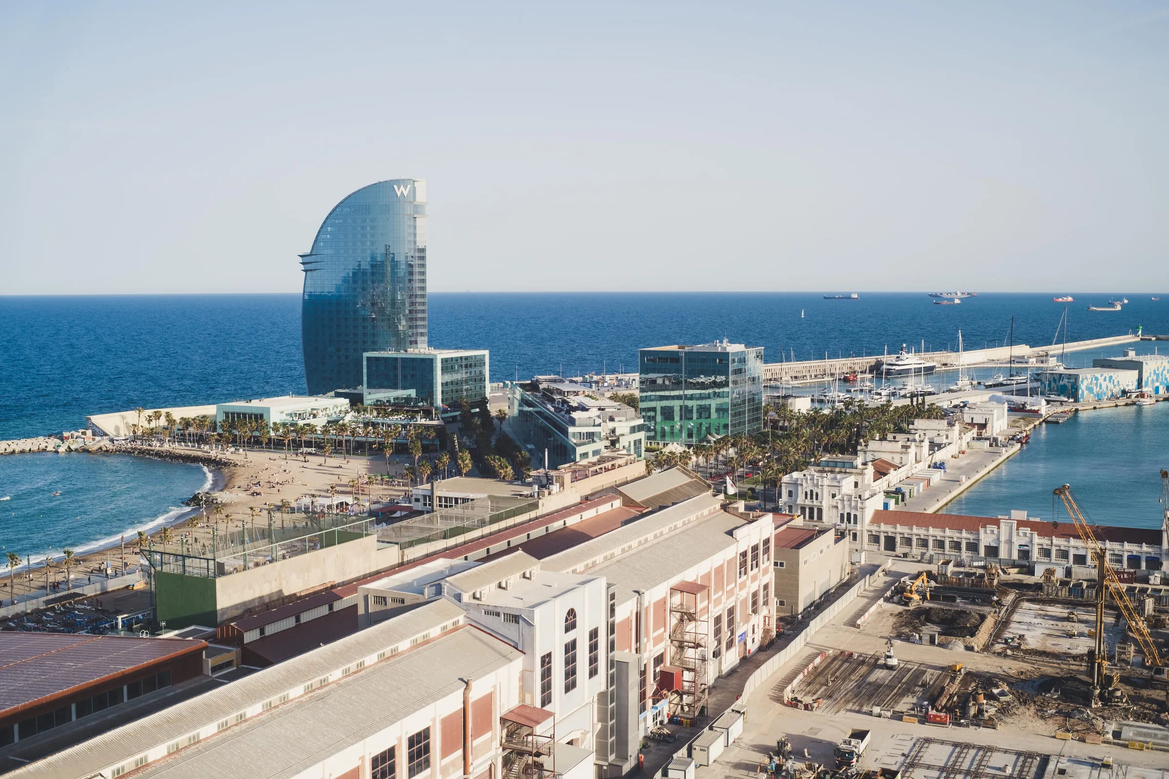 Aerial view of the Barcelona waterfront with the sail-shaped W hotel at the end of the beach